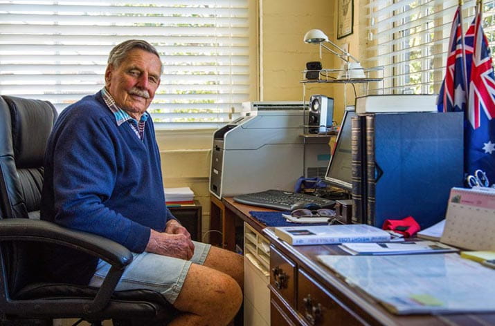 Ernest sitting at his desk